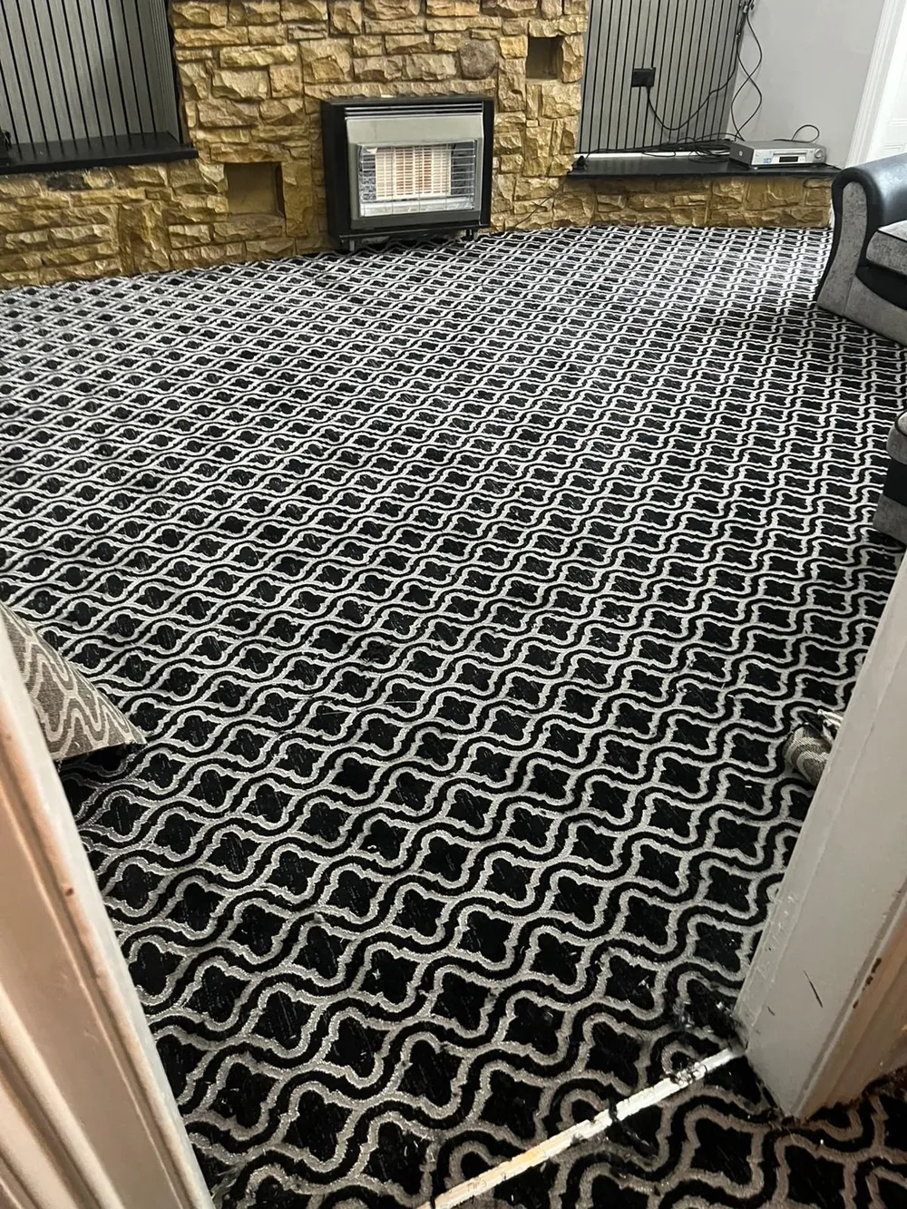 Black and white patterned Wilton carpet in a living room