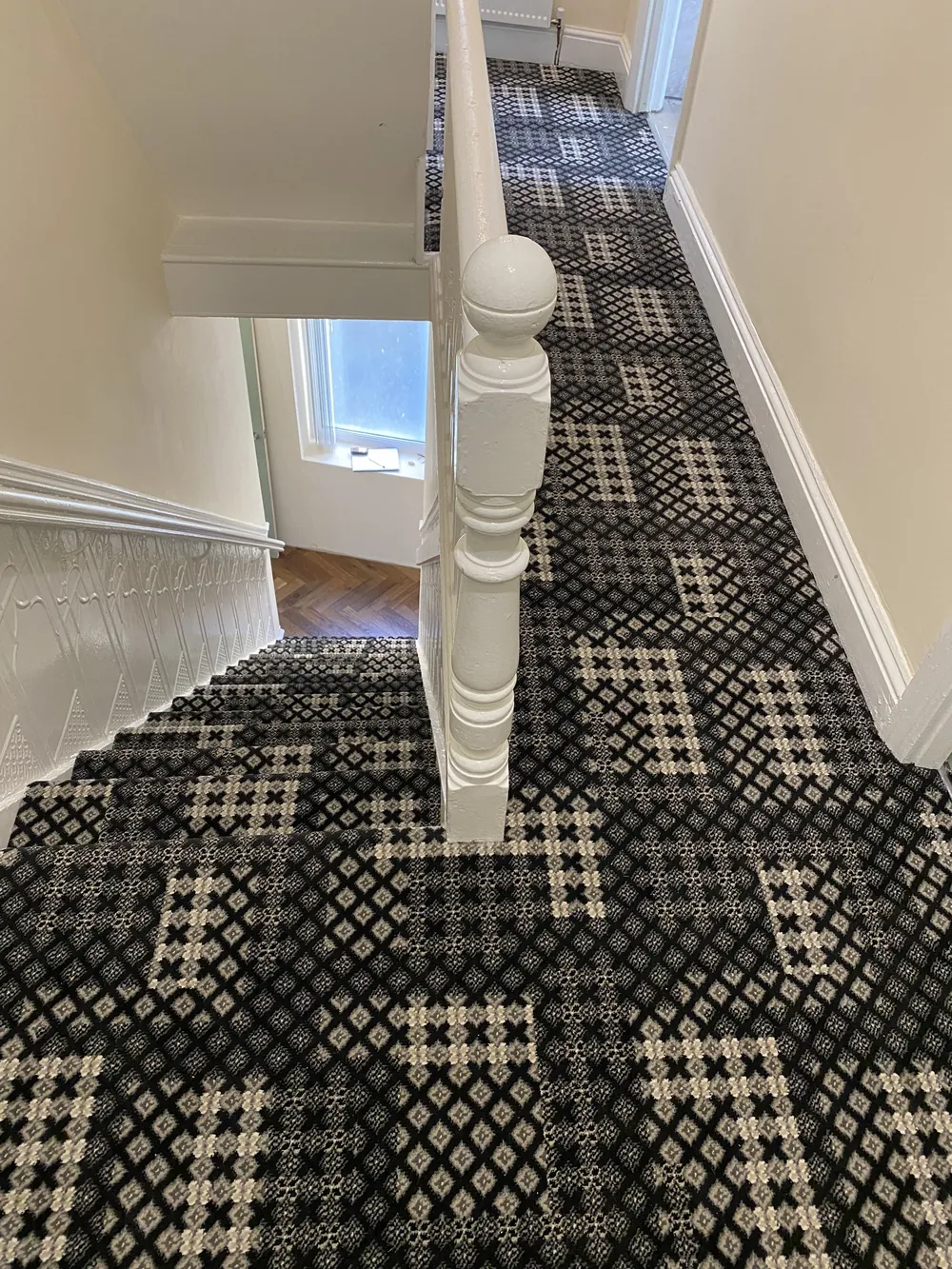 Patchwork-pattern Wilton carpet on a stair and landing