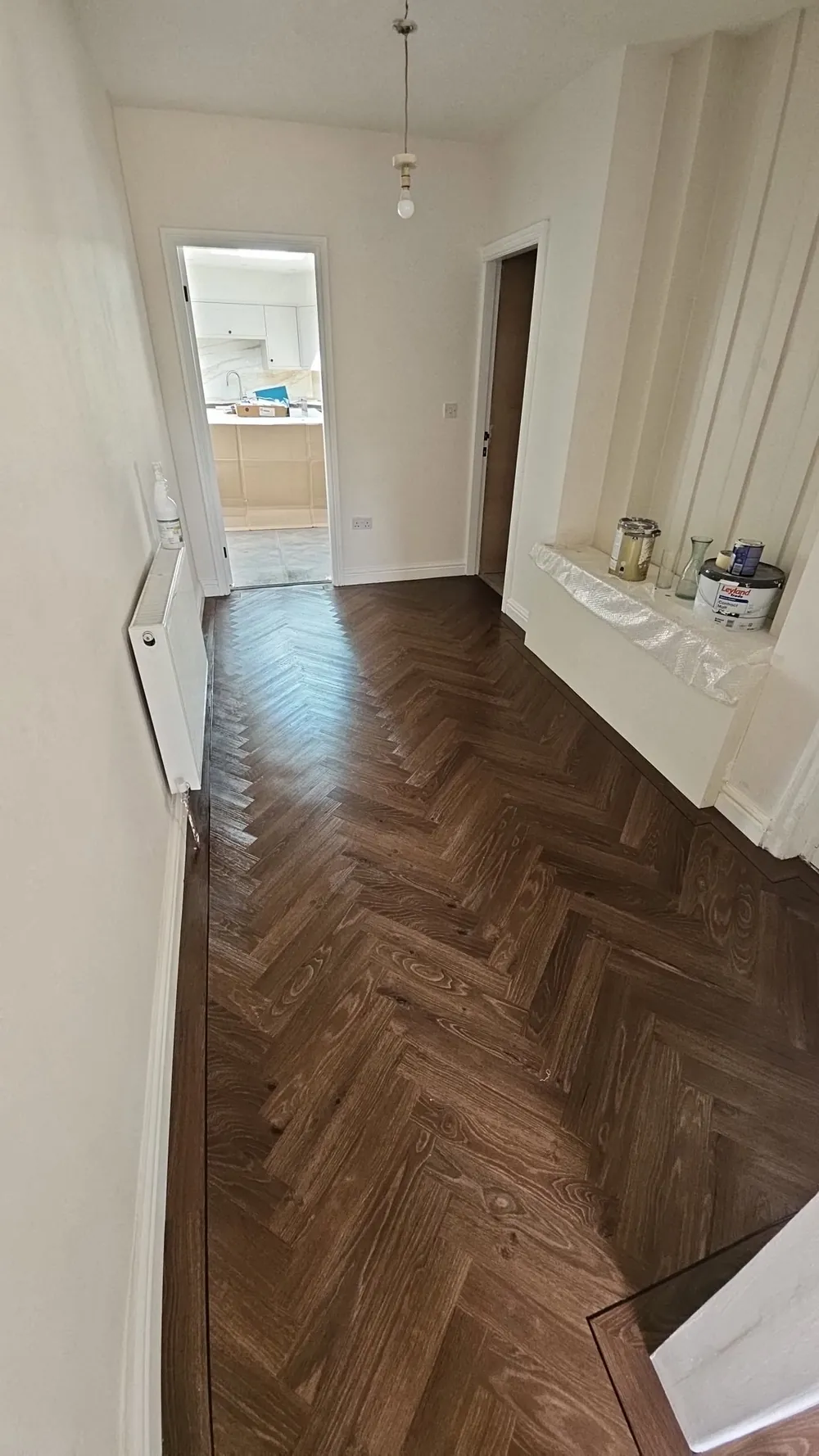 Dark herringbone LVT in a hallway