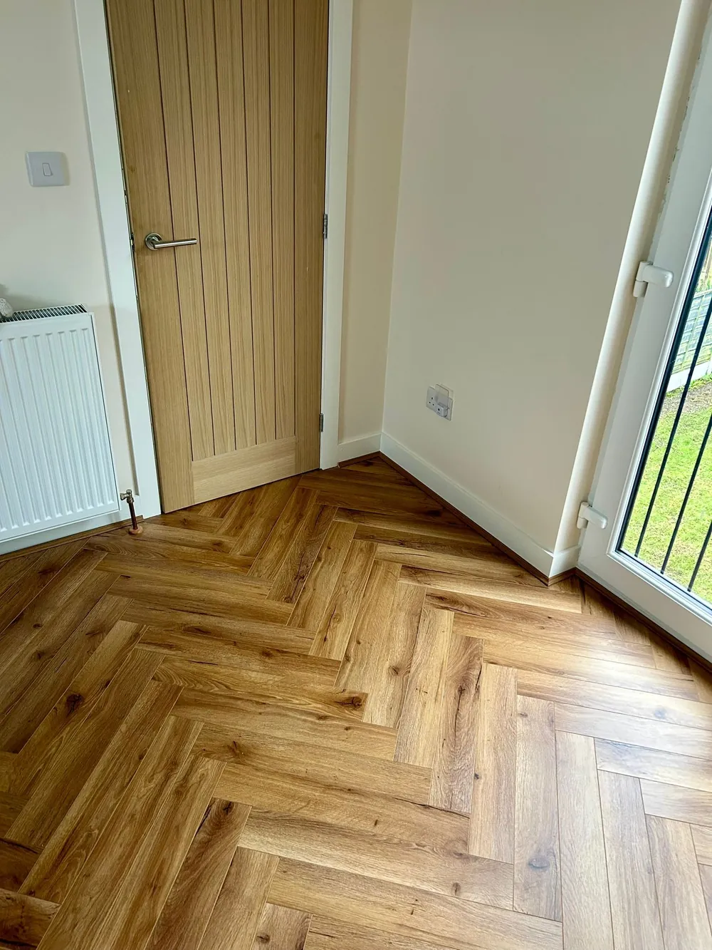 Herringbone laminate by patio doors