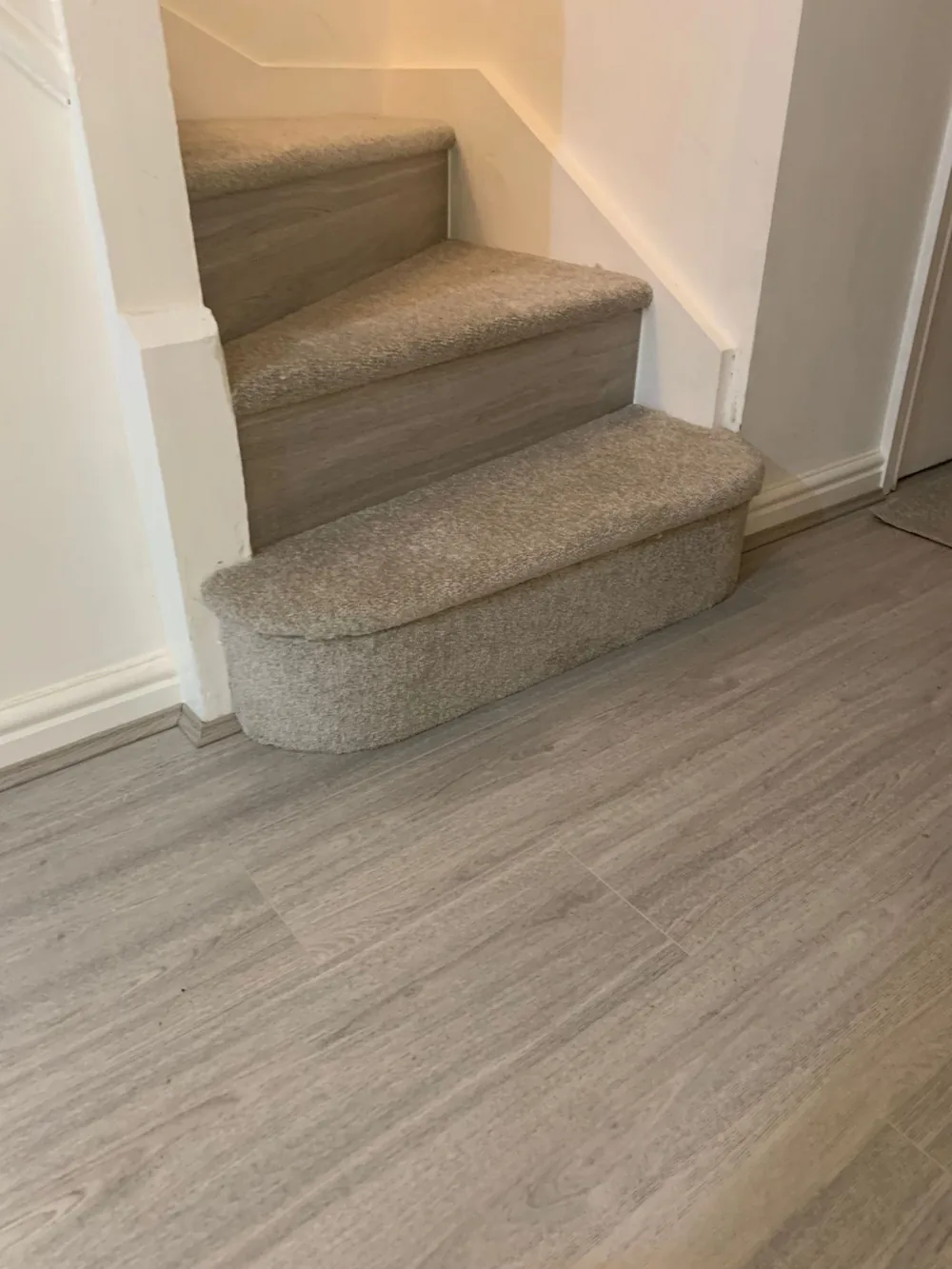 Grey laminate with a carpeted staircase