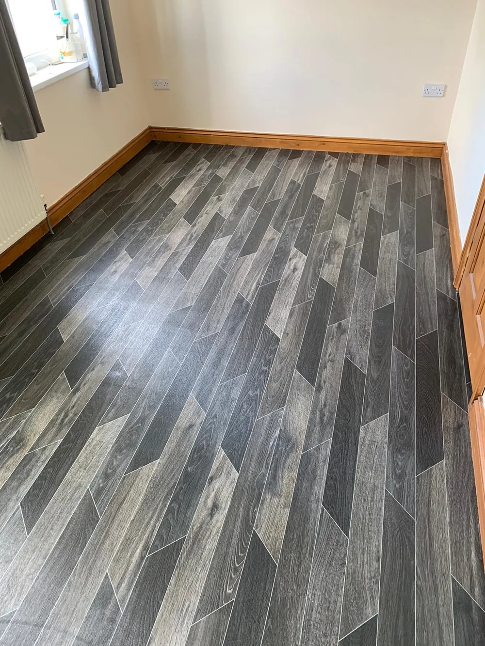 Dark wood-effect vinyl in a bedroom