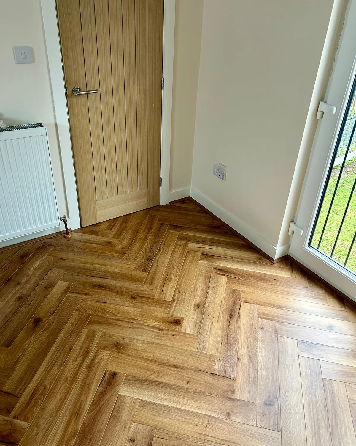 Herringbone laminate by patio doors